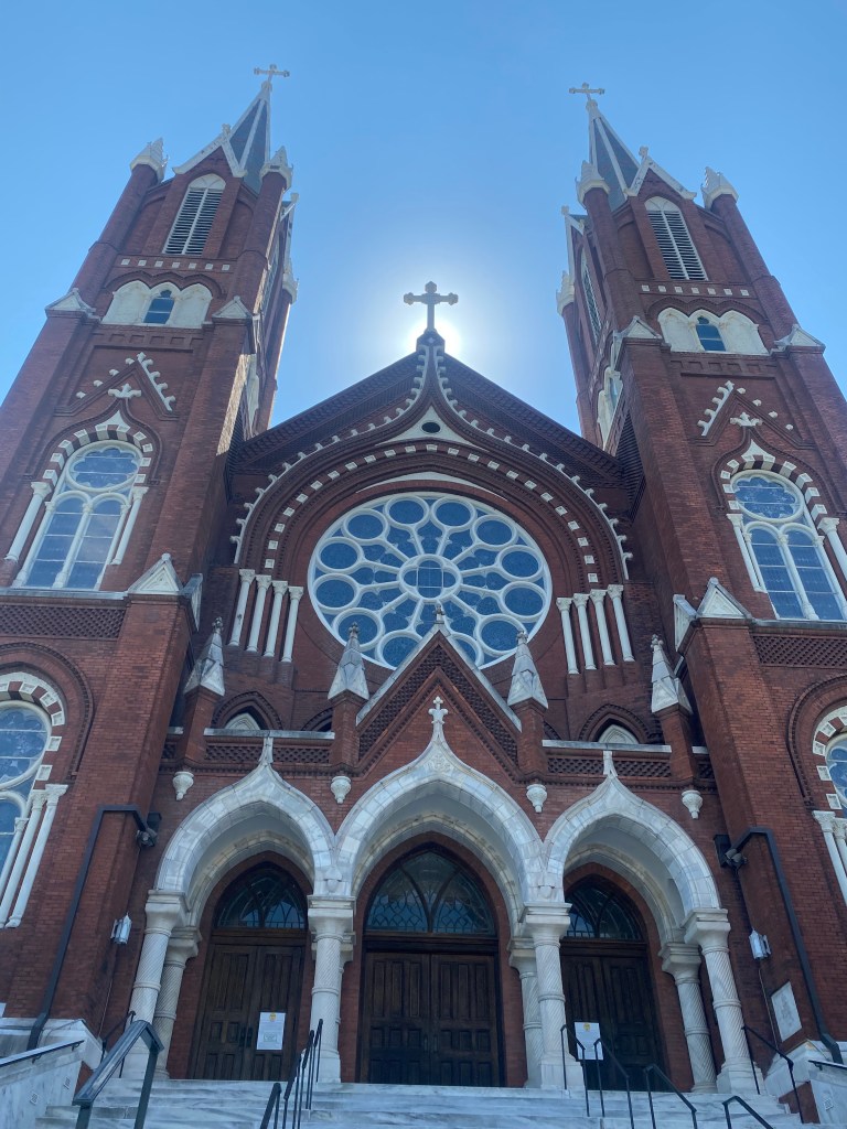 A symmetrical brick church with beautiful windows in Macon, GA.