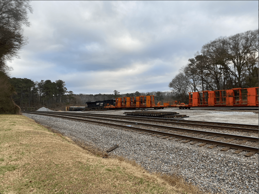 Trains and train tracks extending across the frame into the distance.